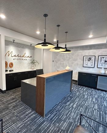 A view of a lobby with a reception desk and lights